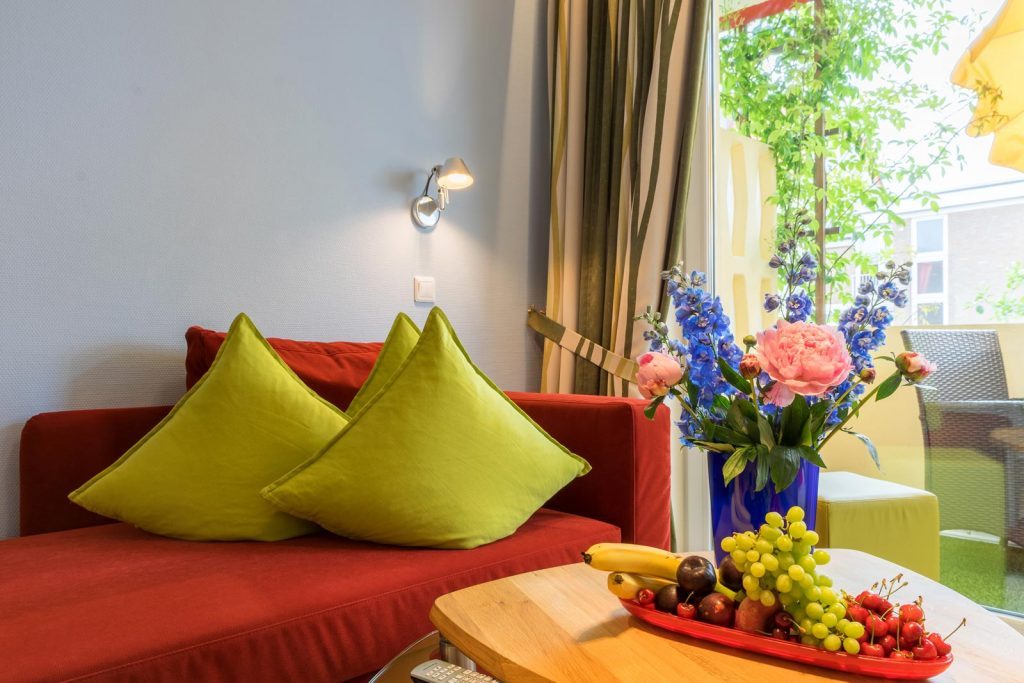 Couch und Couchtisch mit Blumen und Obstschale Apartment Steuerbord
